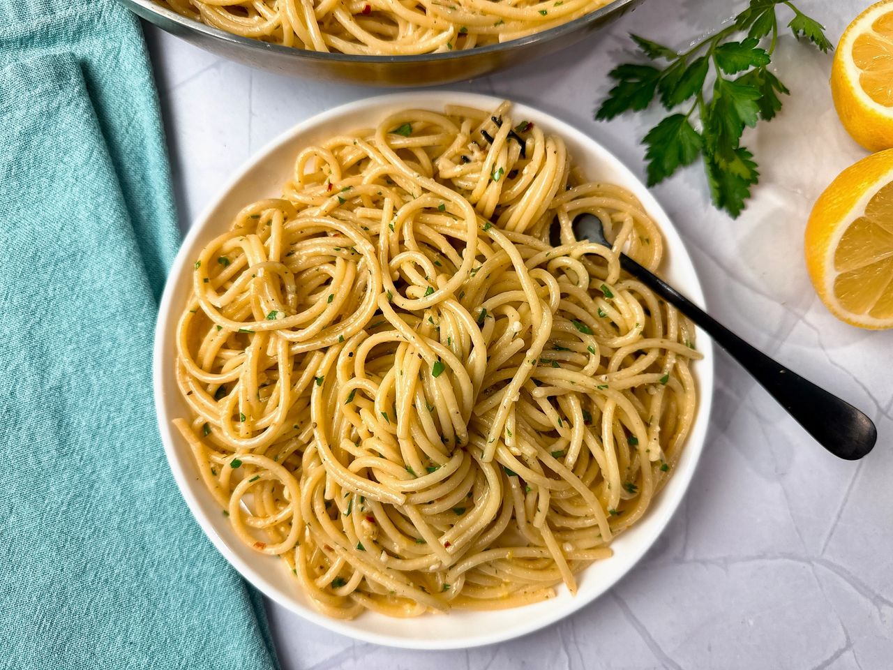 Lemon Garlic Pasta in a white bowl with a black fork