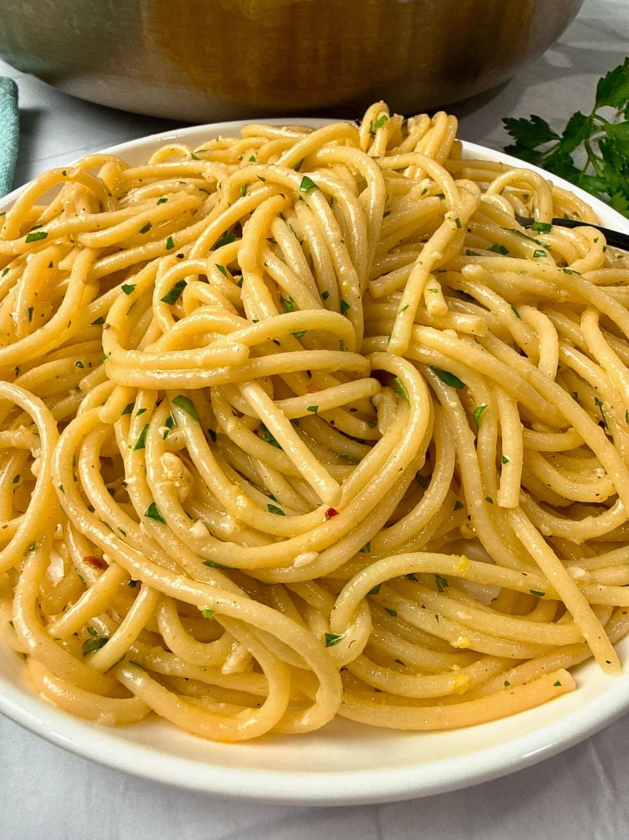 Lemon Garlic Pasta in a white bowl with a black fork