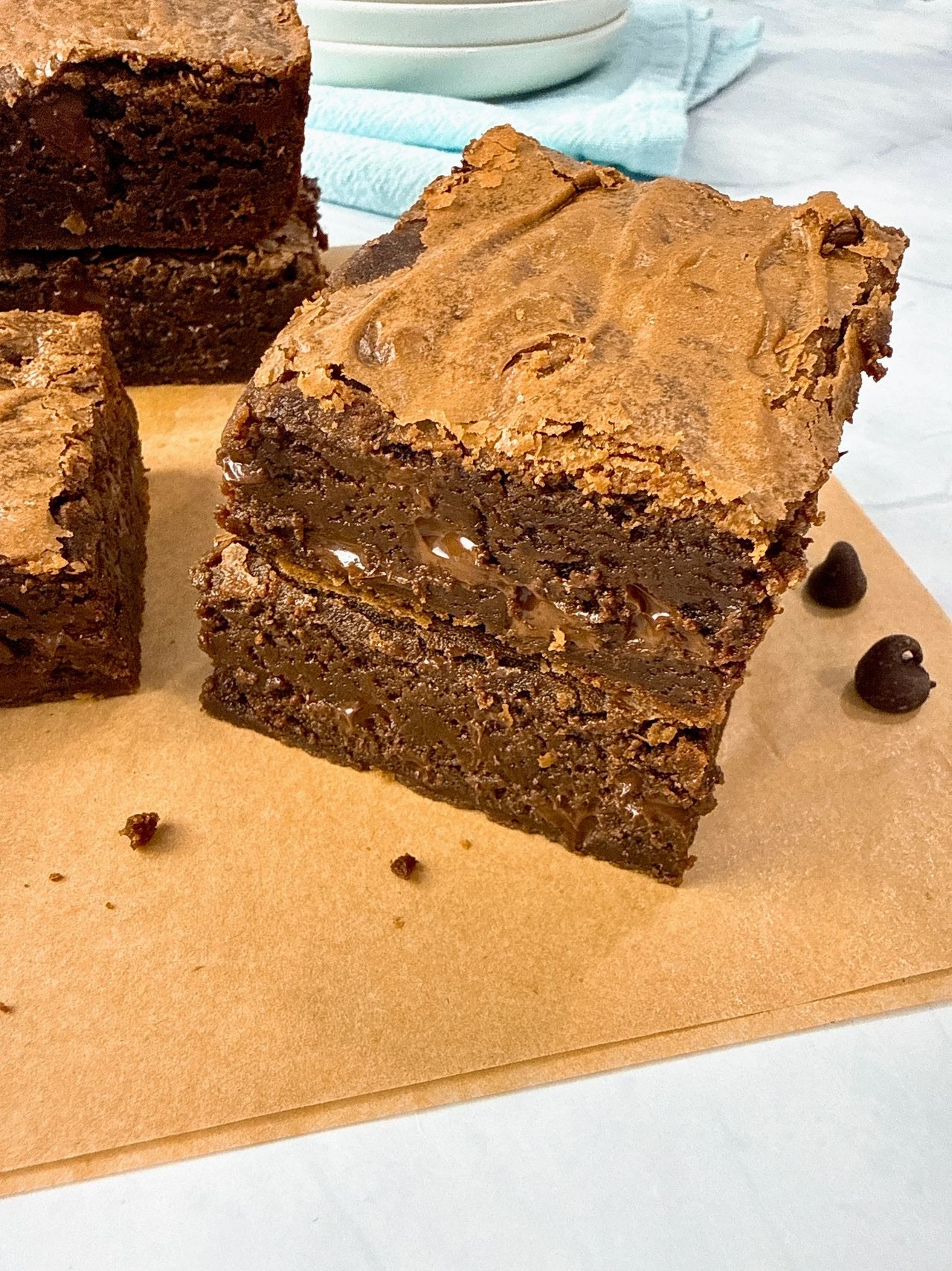 Ultimate Brownies on brown parchment paper