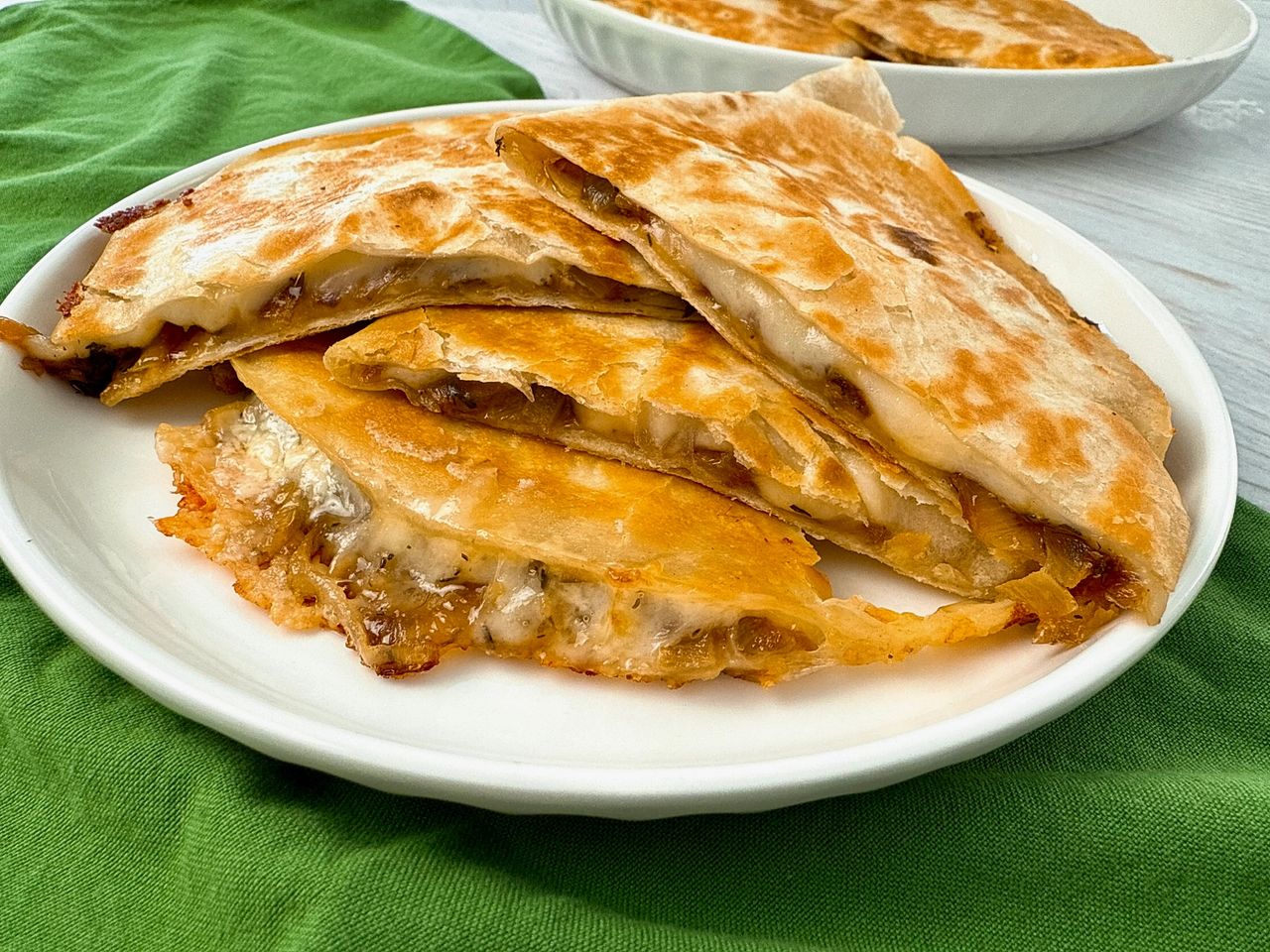 French Onion Quesadillas stacked on a white plate