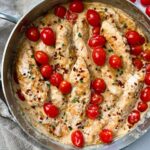 Boursin Chicken in a skillet with grape tomatoes