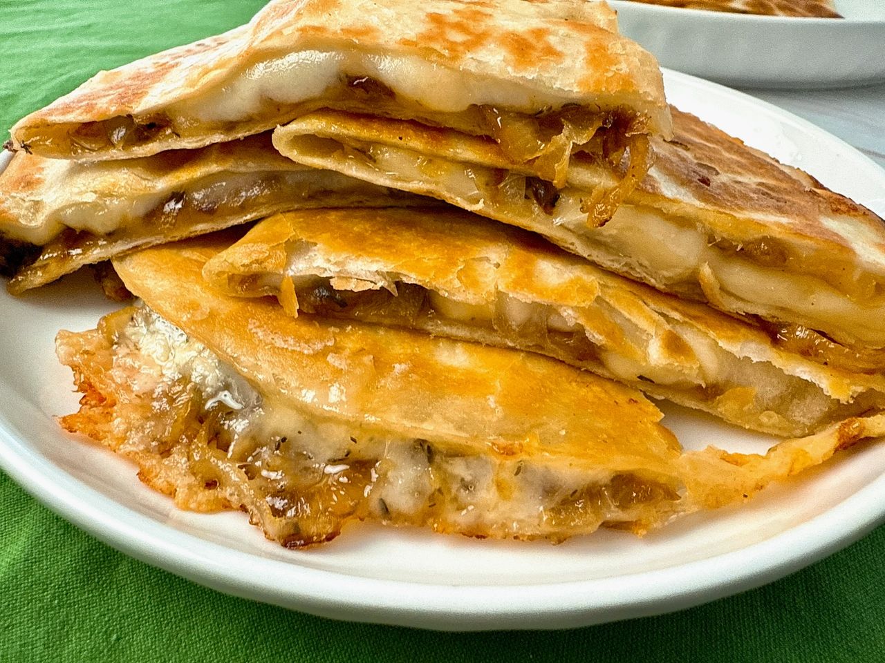 French Onion Quesadillas stacked on a white plate