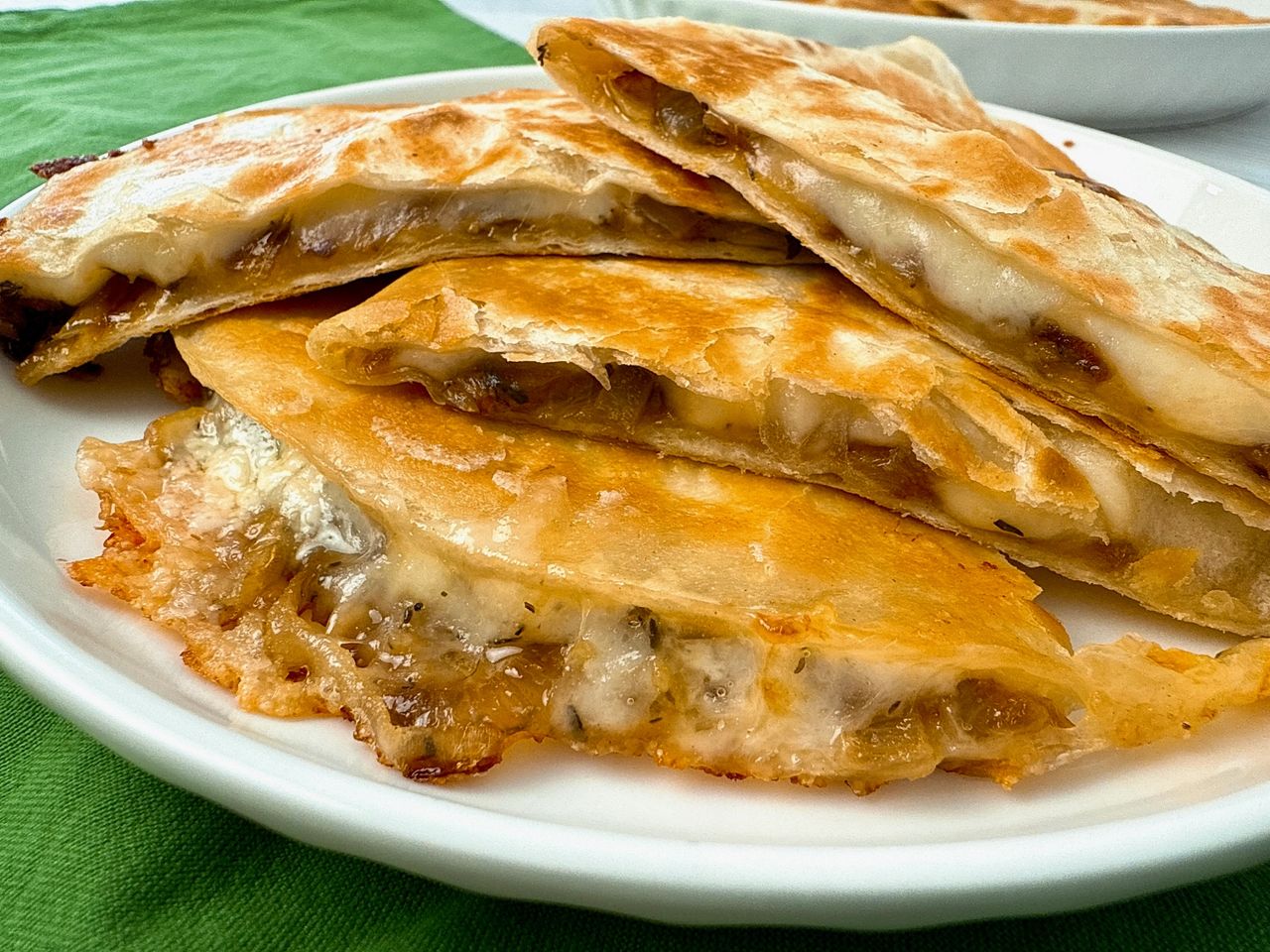 French Onion Quesadillas stacked on a white plate