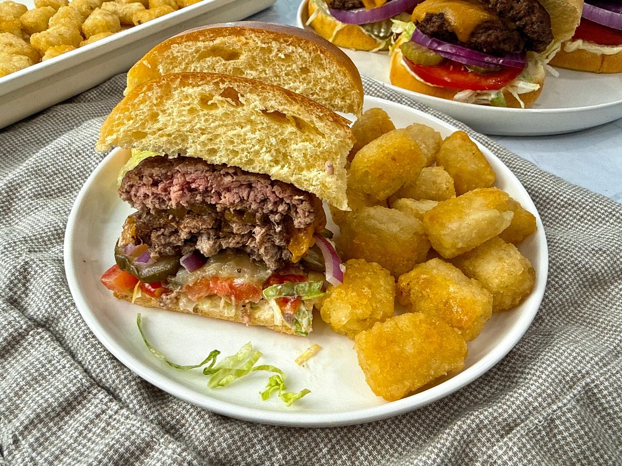 Smash Burgers Smash Burgers on a white plate with tater tots