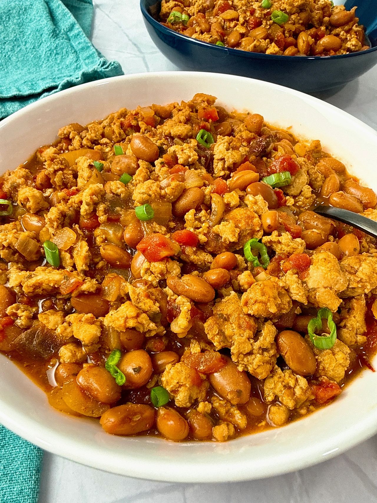 chicken chili ini a white bowl with a spoon