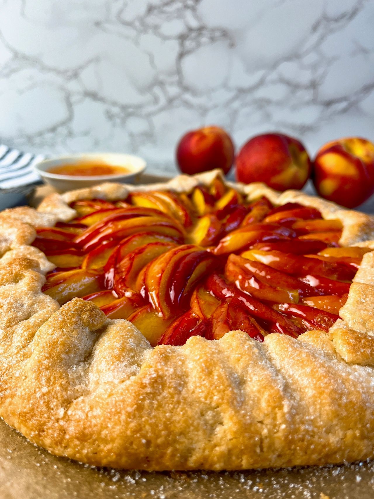 Easy Peach Galette with peaches in the background