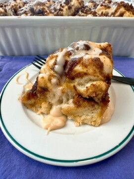 Cinnamon Roll Focaccia in a white baking dish and on a dessert plate with a fork