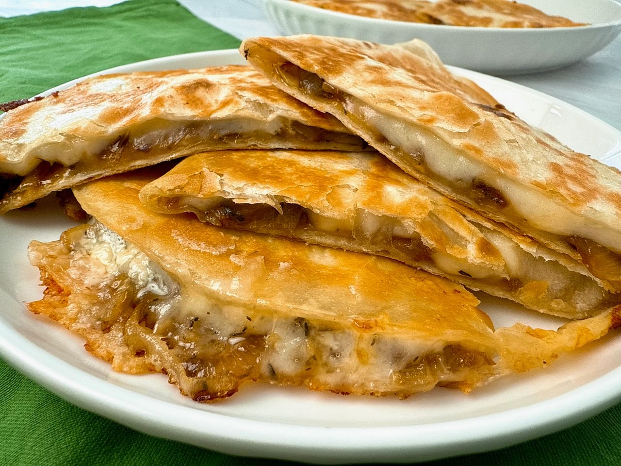 French Onion Quesadillas stacked on a white plate