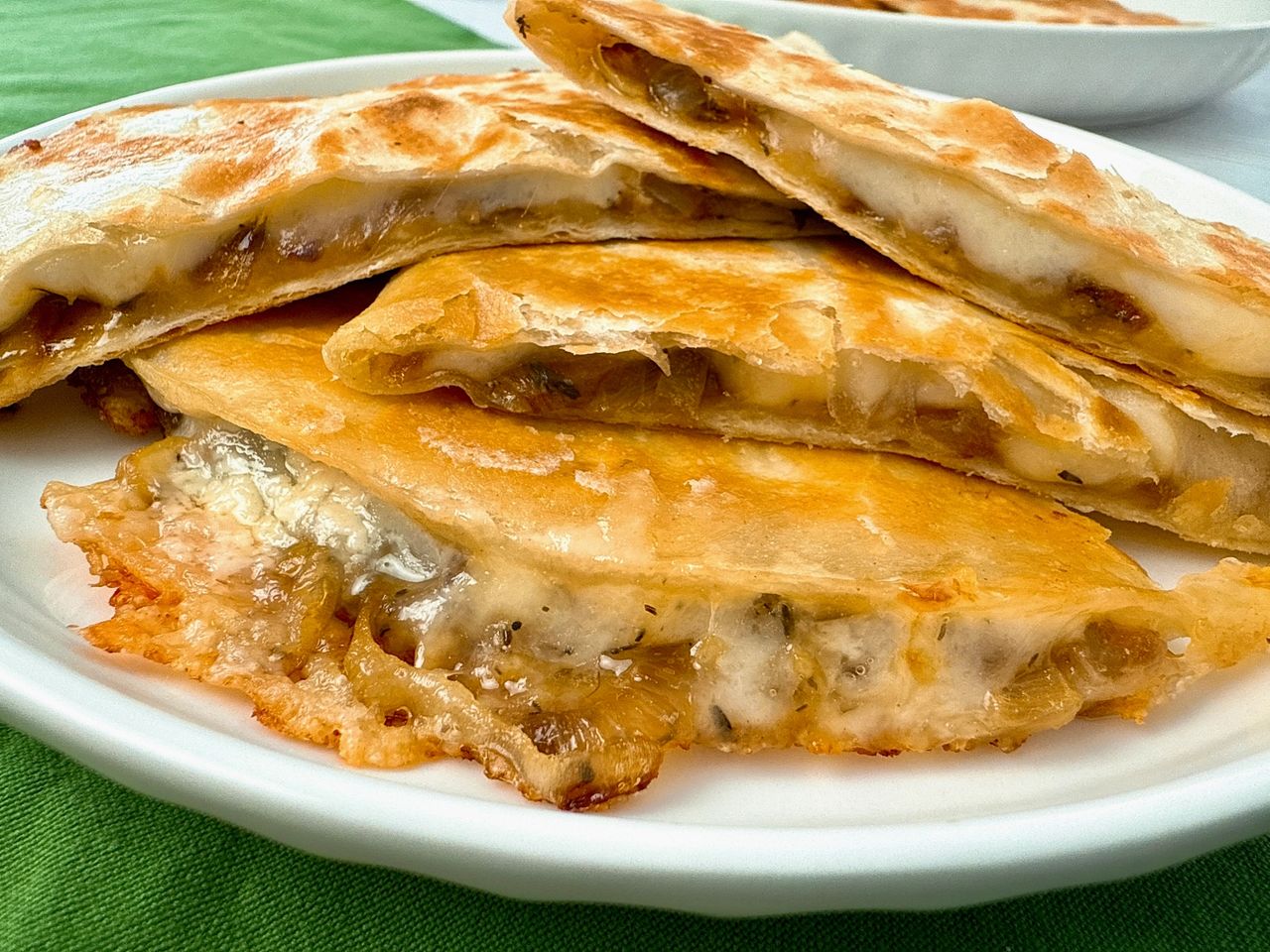 French Onion Quesadillas stacked on a white plate