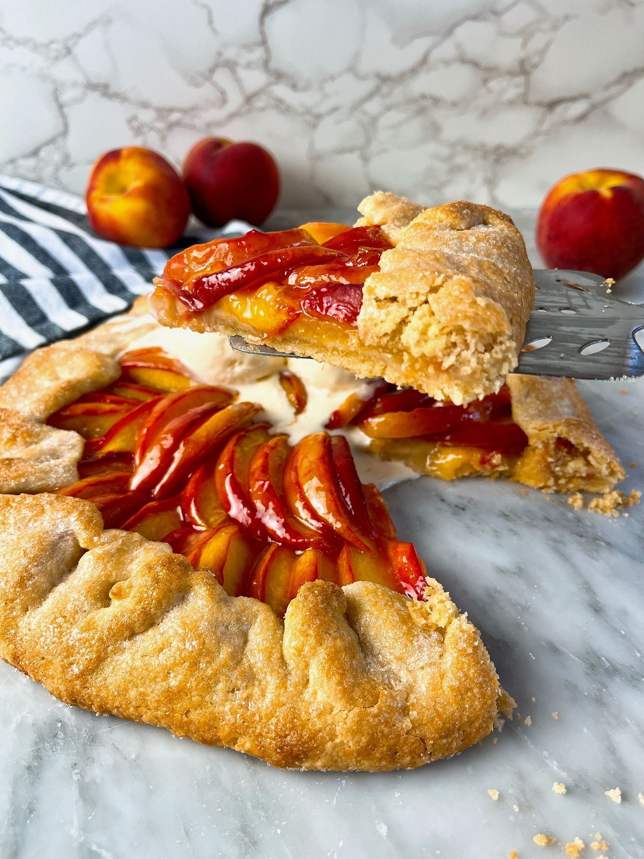 slice of peach galette on a spatula