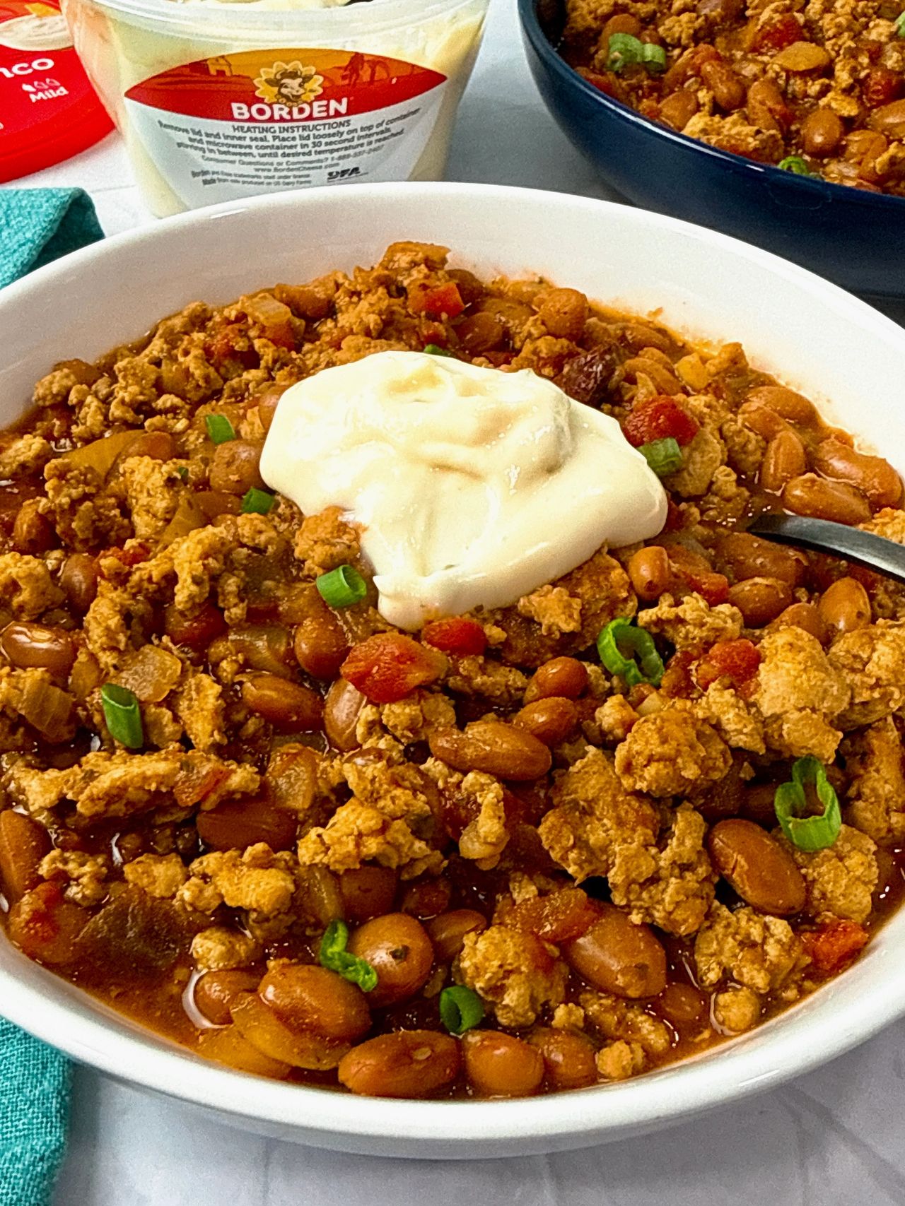 chicken chili ini a white bowl with a spoon