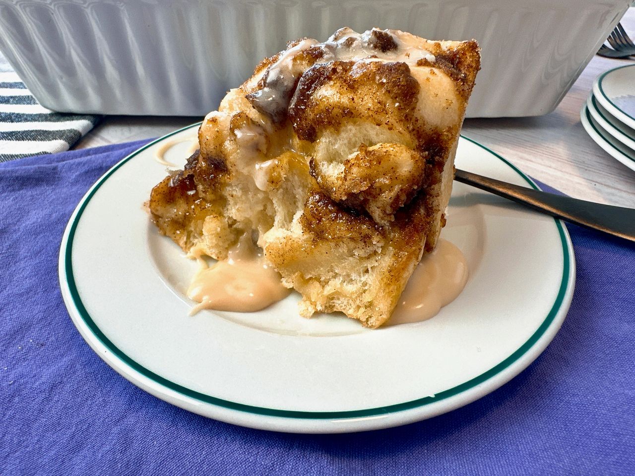 cinnamon roll focaccia on a white plate with a black fork