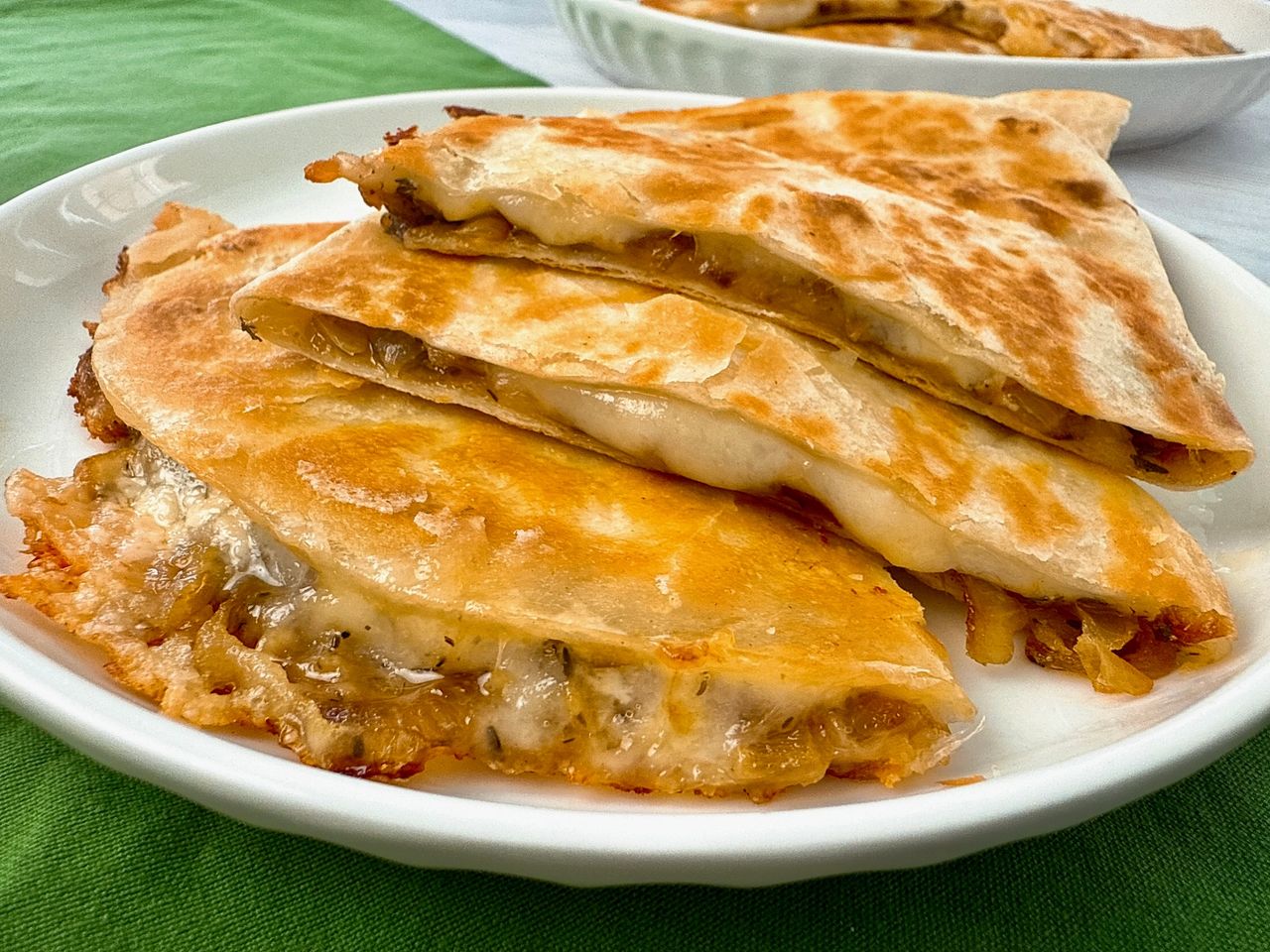 French Onion Quesadillas stacked on a white plate