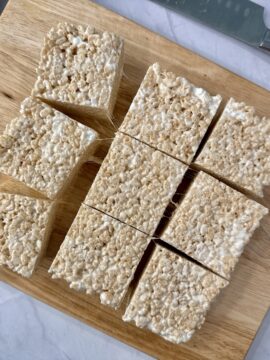 rice krispie treats on a wooden cutting board