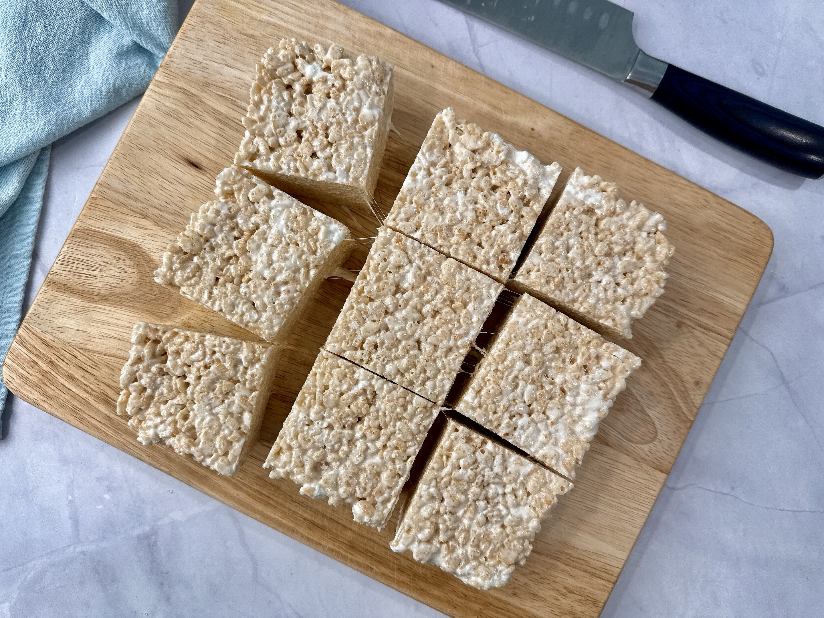 rice krispie treats on a wooden cutting board