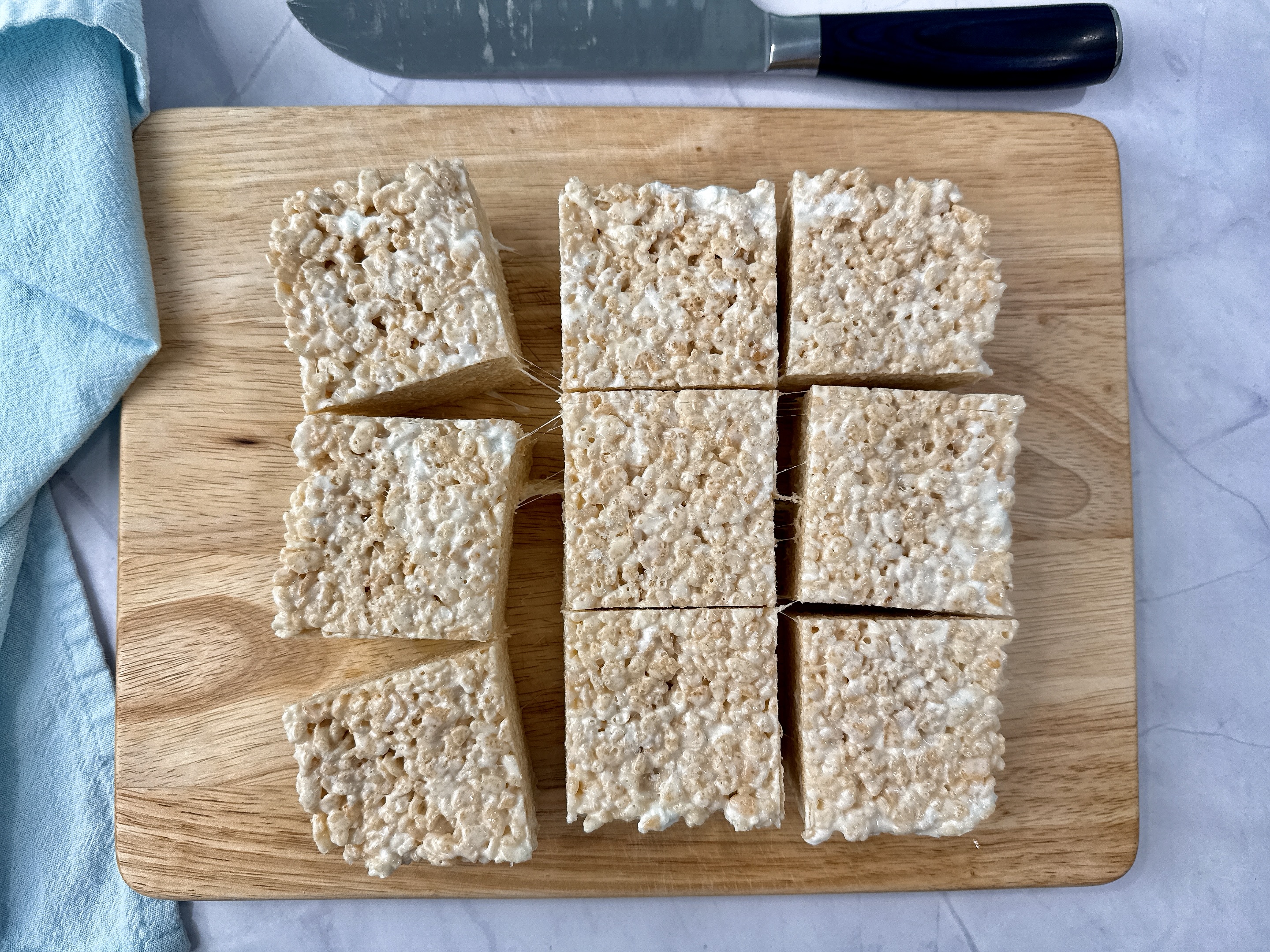 rice krispie treats on a wooden cutting board