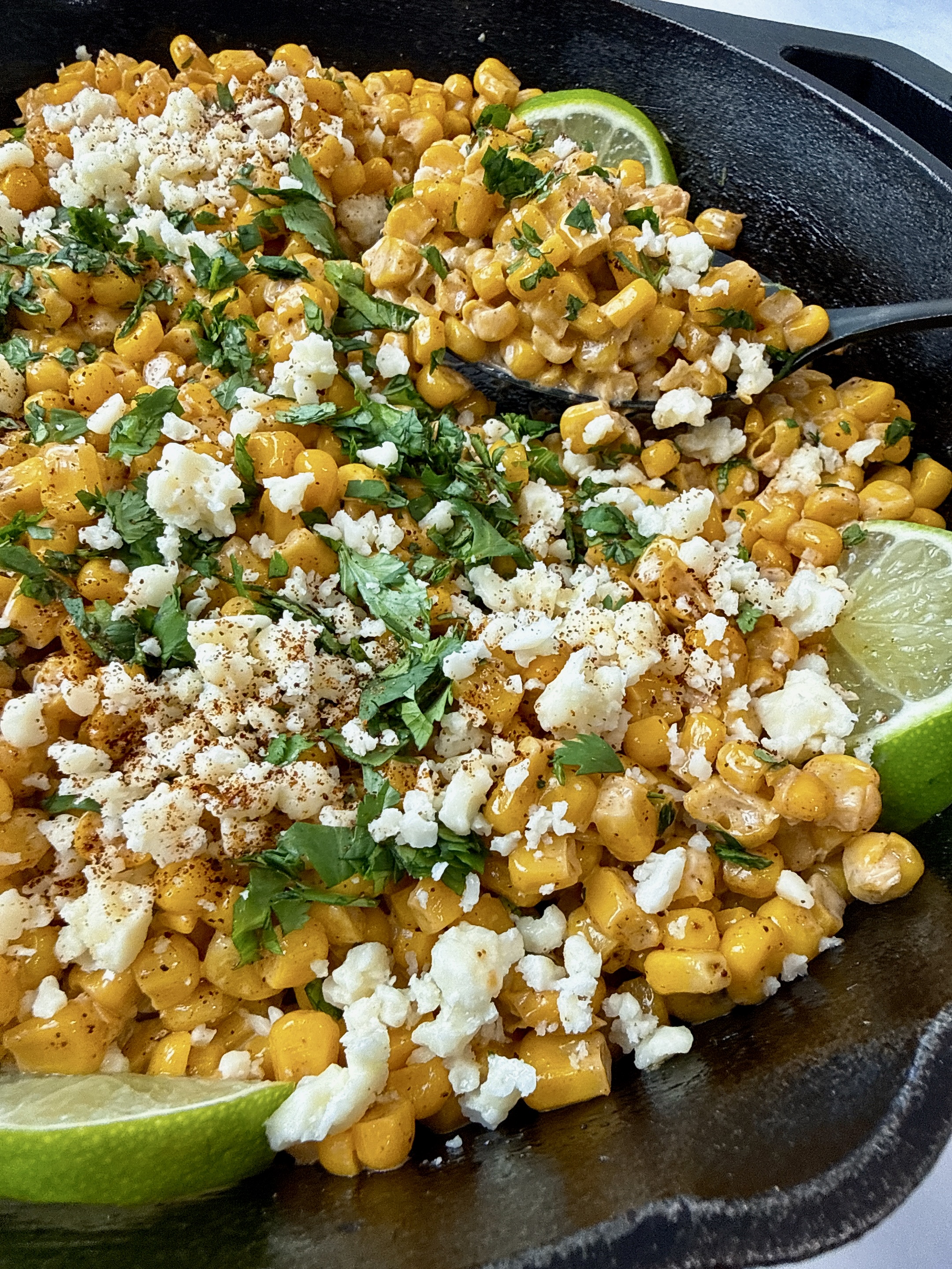 Mexican street corn in a cast iron skillet