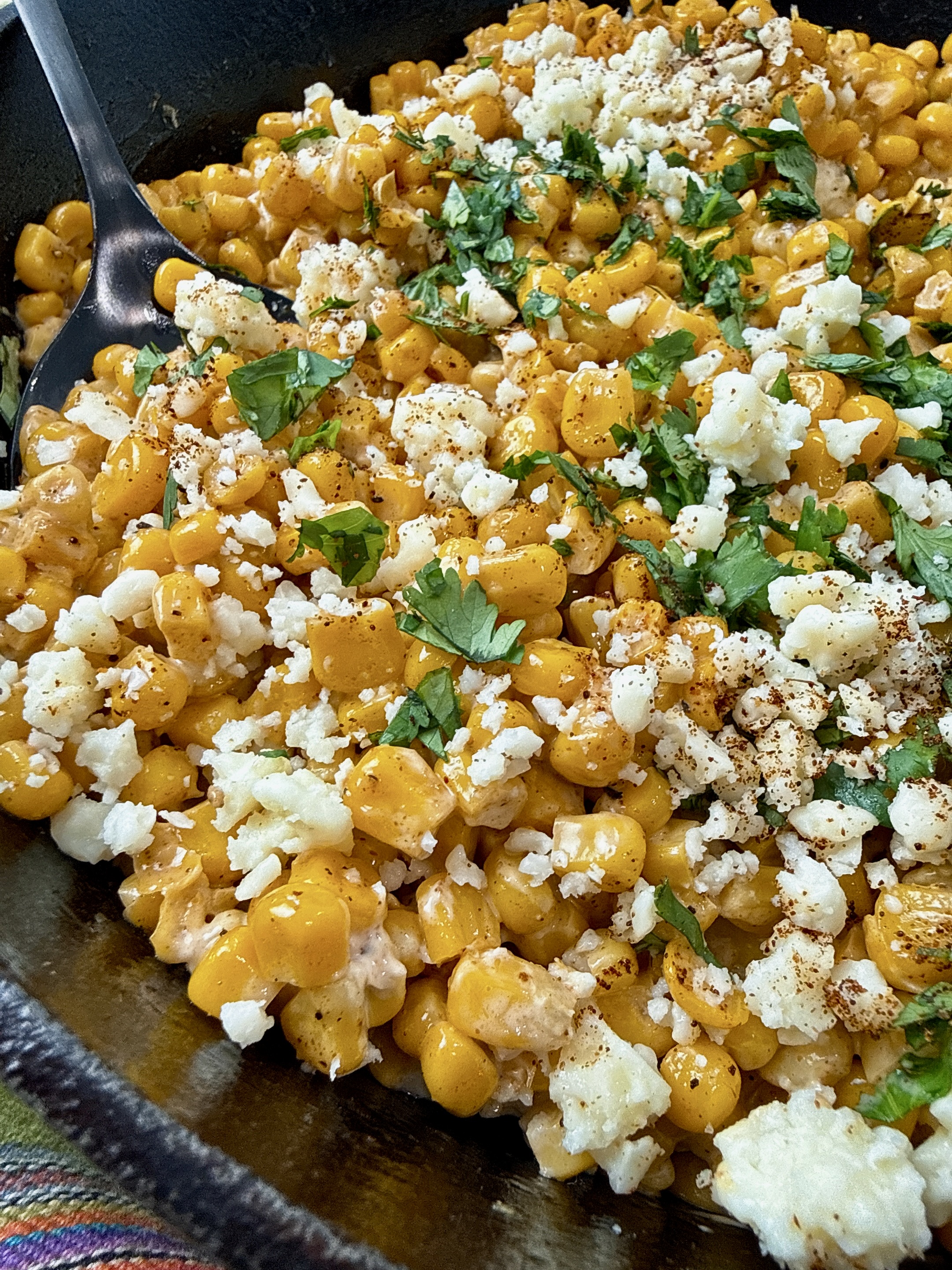 Mexican street corn in a cast iron skillet