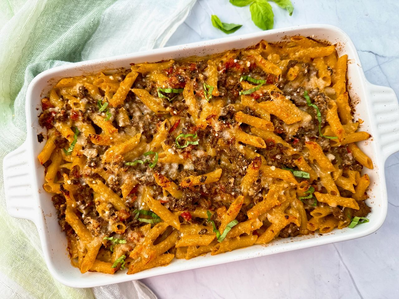 pasta and beef in a white baking dish