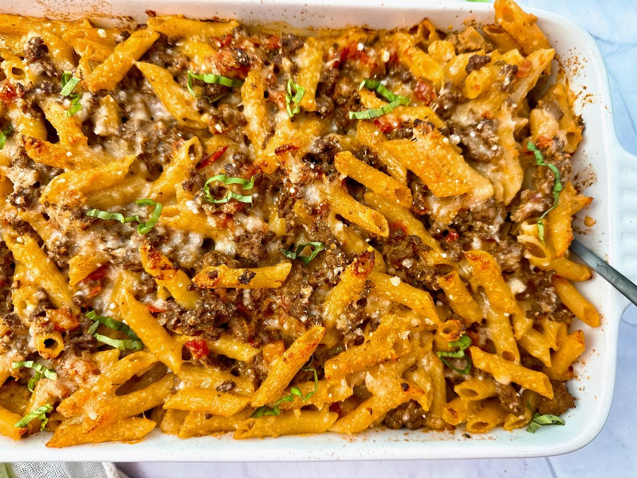 pasta and beef in a white baking dish