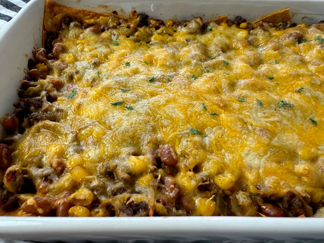 enchilada casserole in a white baking dish