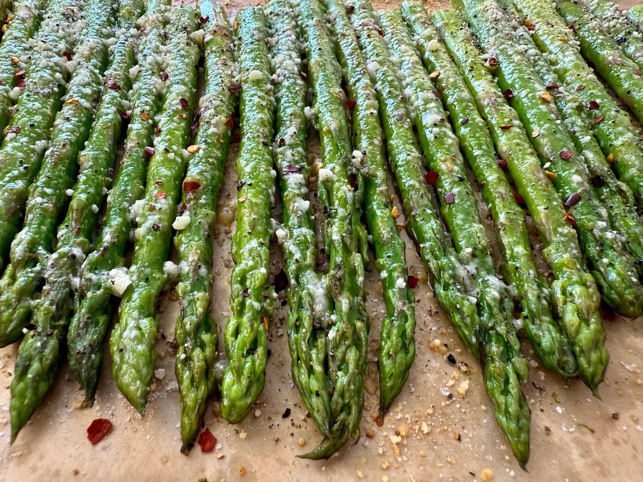 roasted asparagus on a sheet pan lined with parchment paper