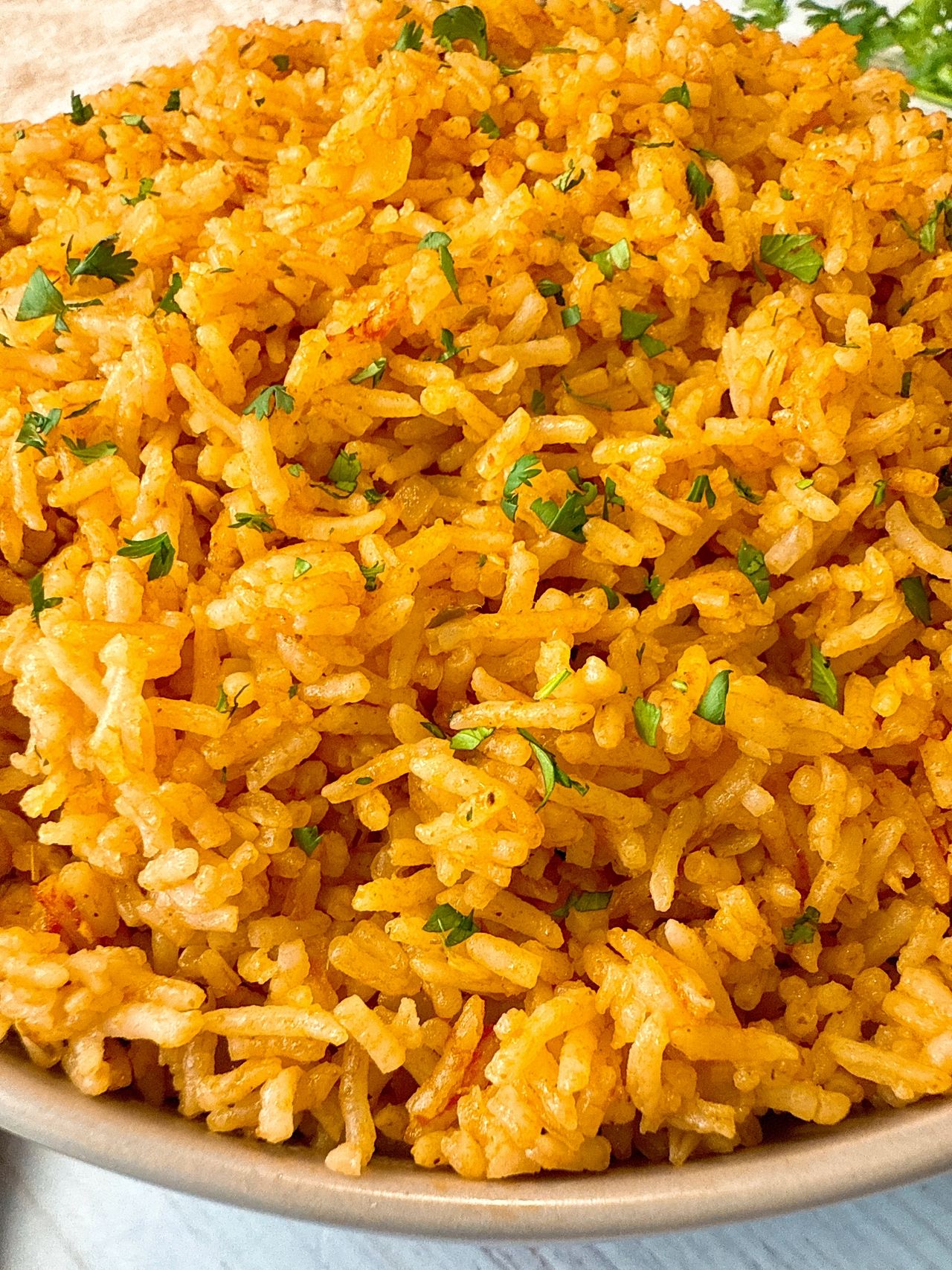 spanish rice in a tan bowl