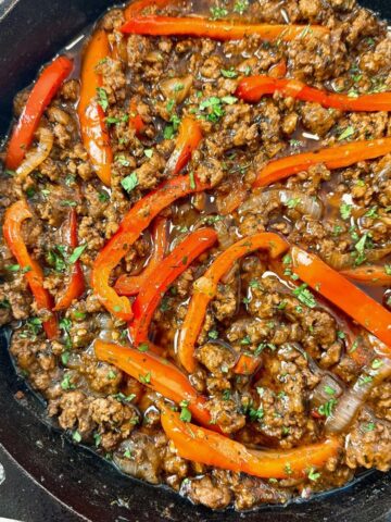 ground beef and peppers in a cast iron skillet