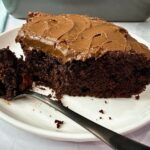 chocolate mayonnaise cake on a white plate with a black fork
