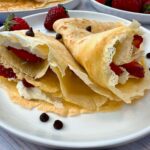 Crepes filled with mascarpone cheese and served with strawberries