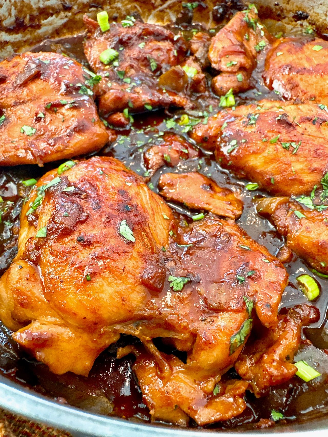 chicken thighs in a skillet with Asian glaze
