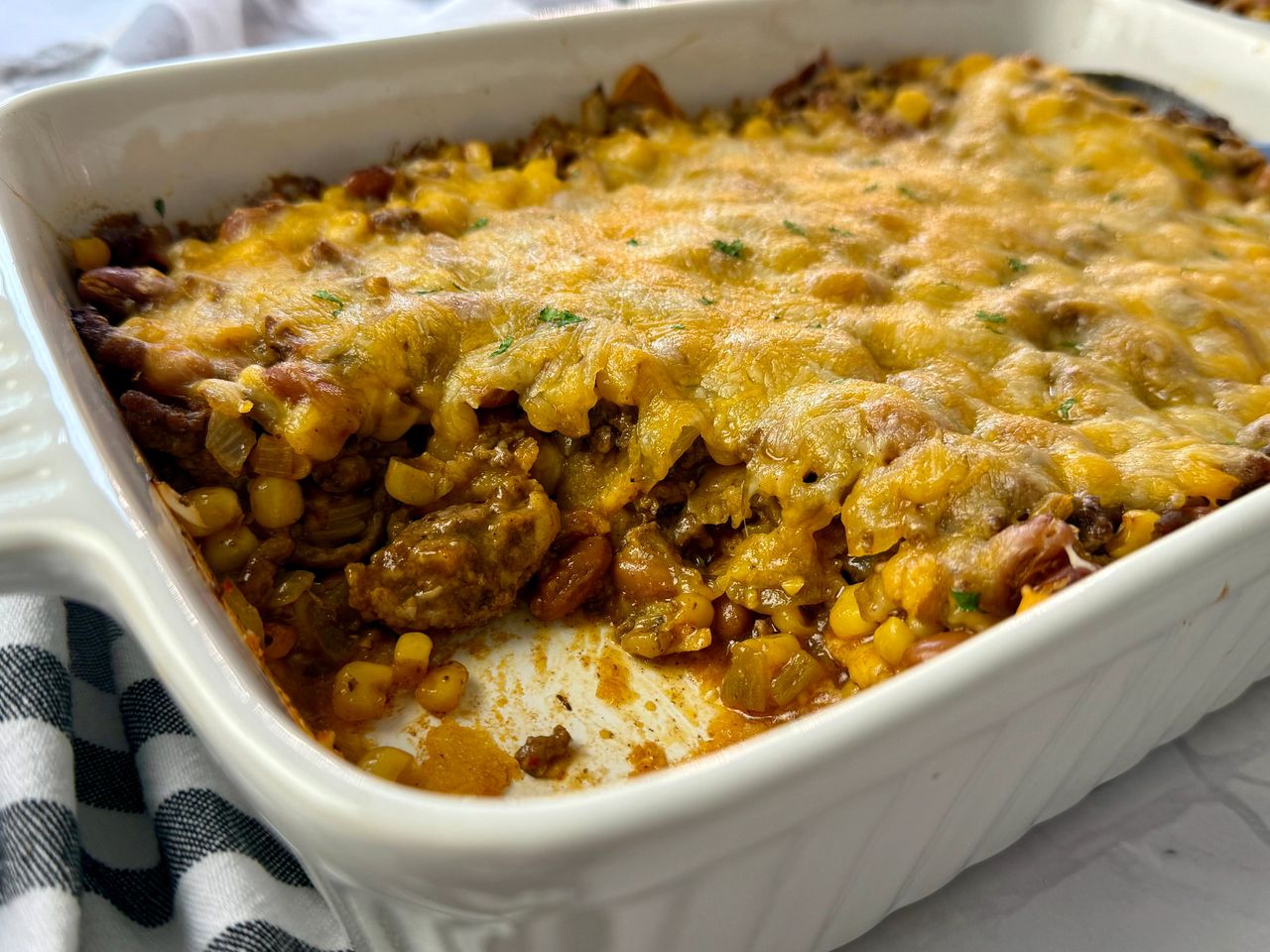 enchilada casserole in a white baking dish