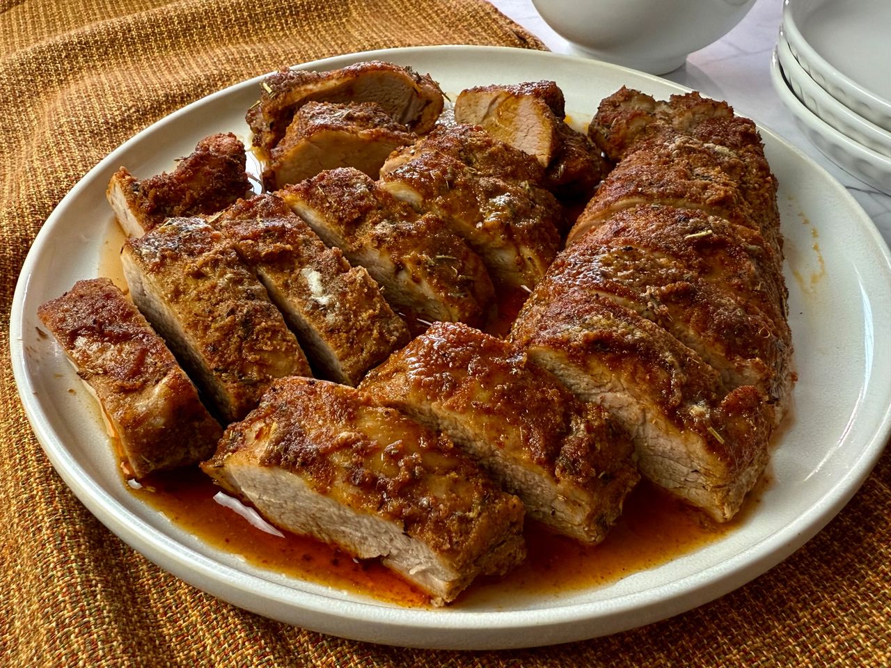 sliced pork tenderloin on a white plate
