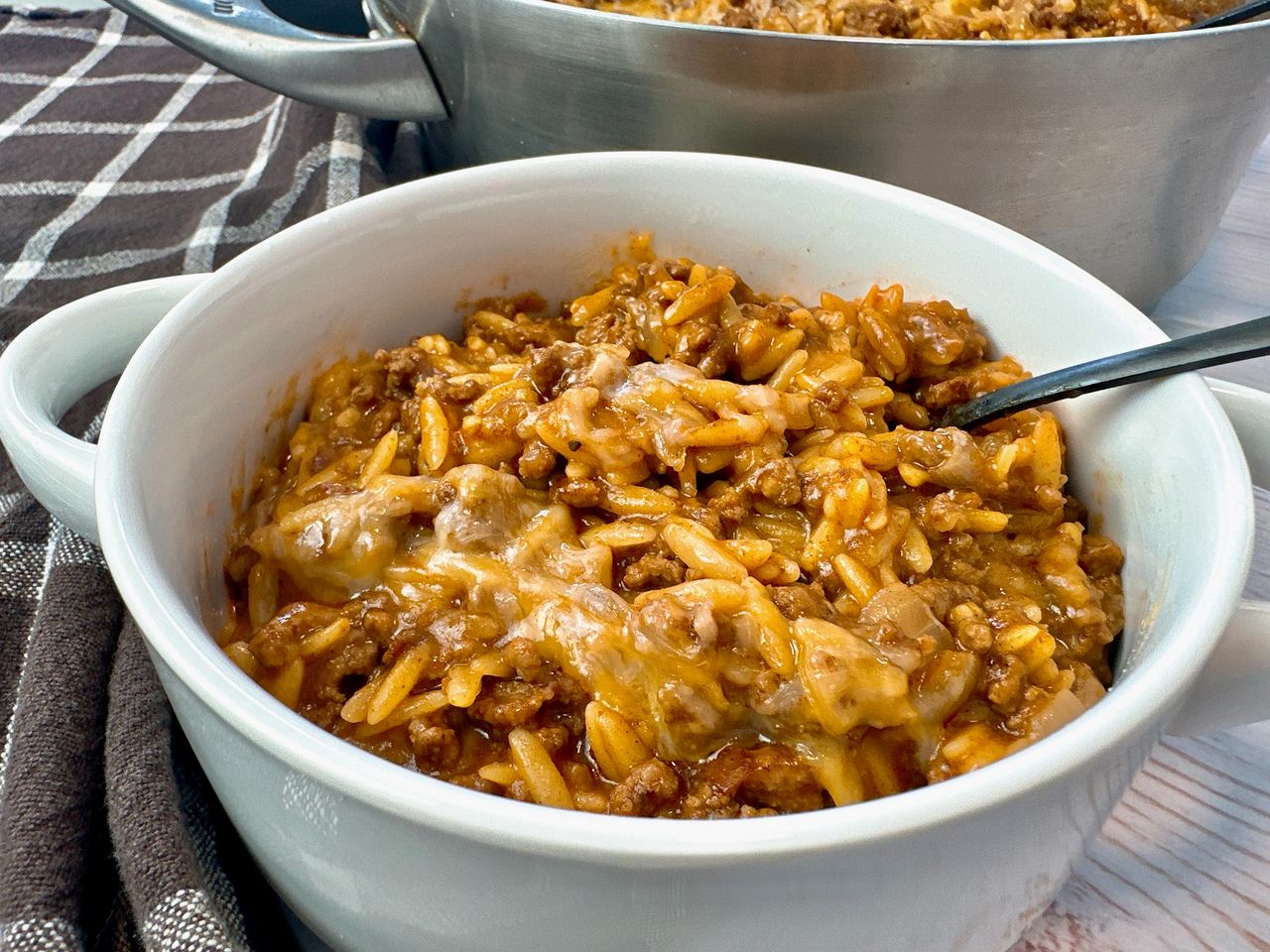 One Pan Taco Beef and Pasta ground beef and pasta in a white bowl