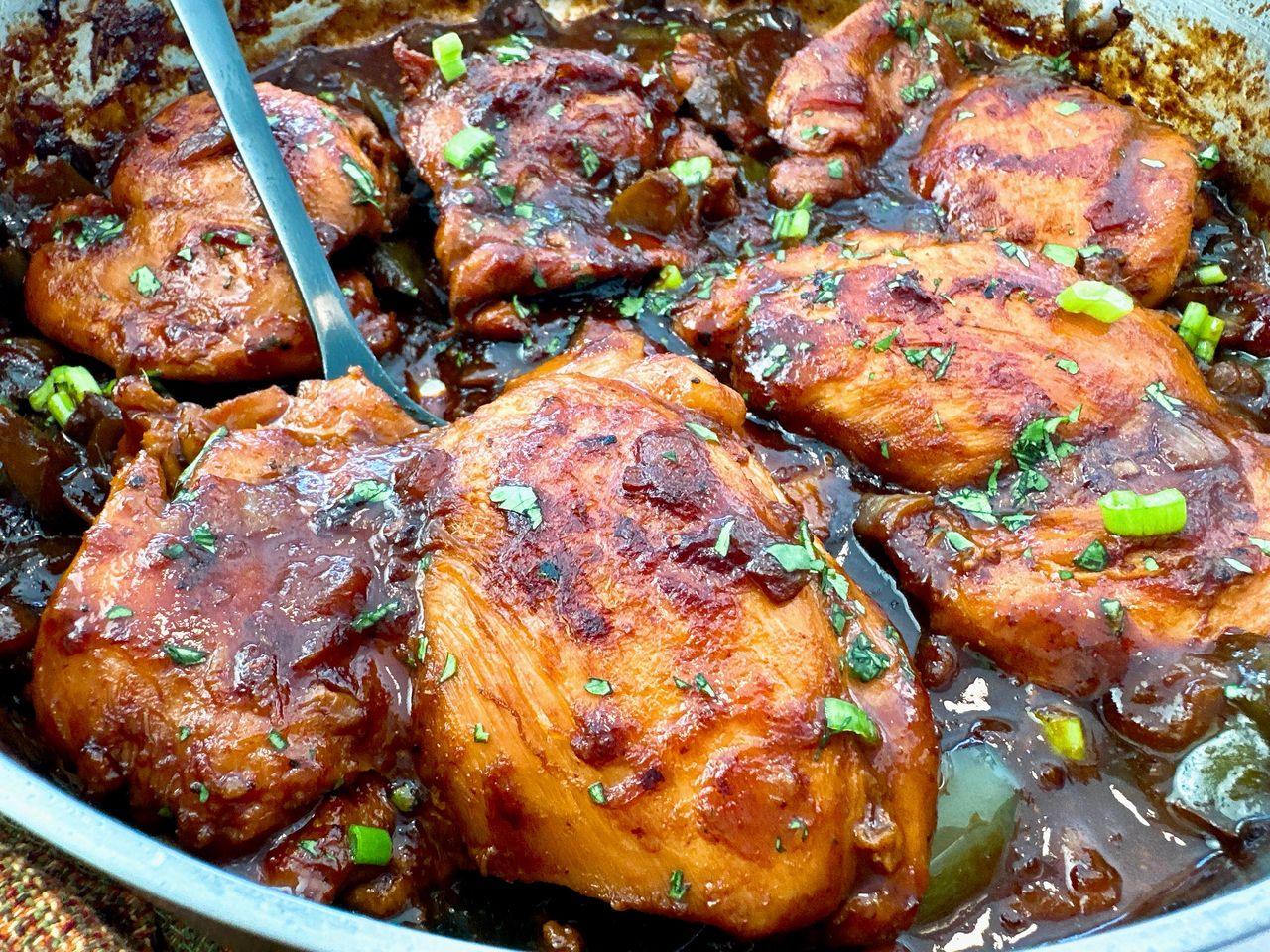 chicken thighs in a skillet with Asian glaze