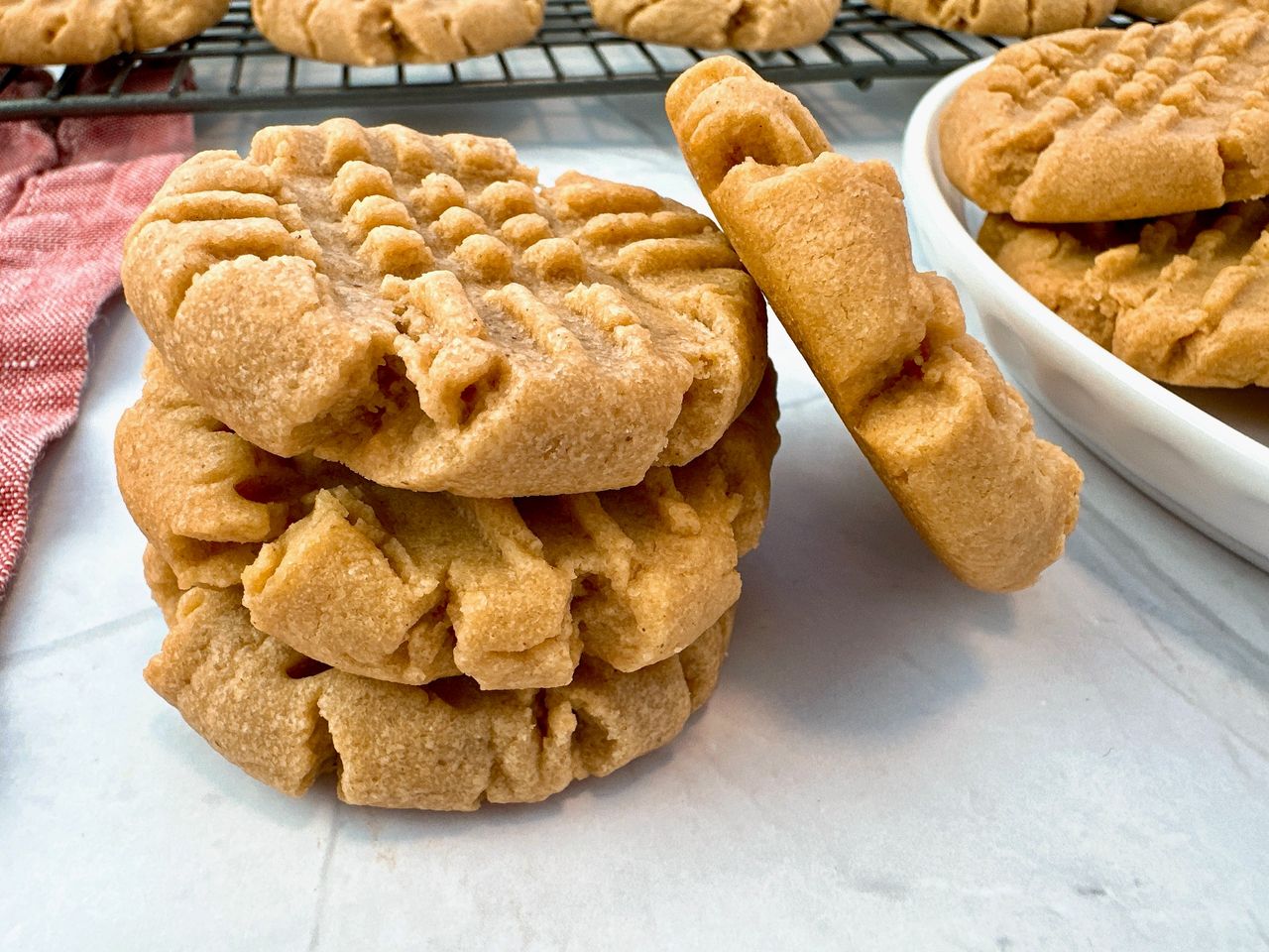 stacked peanut butter cookies on a white background