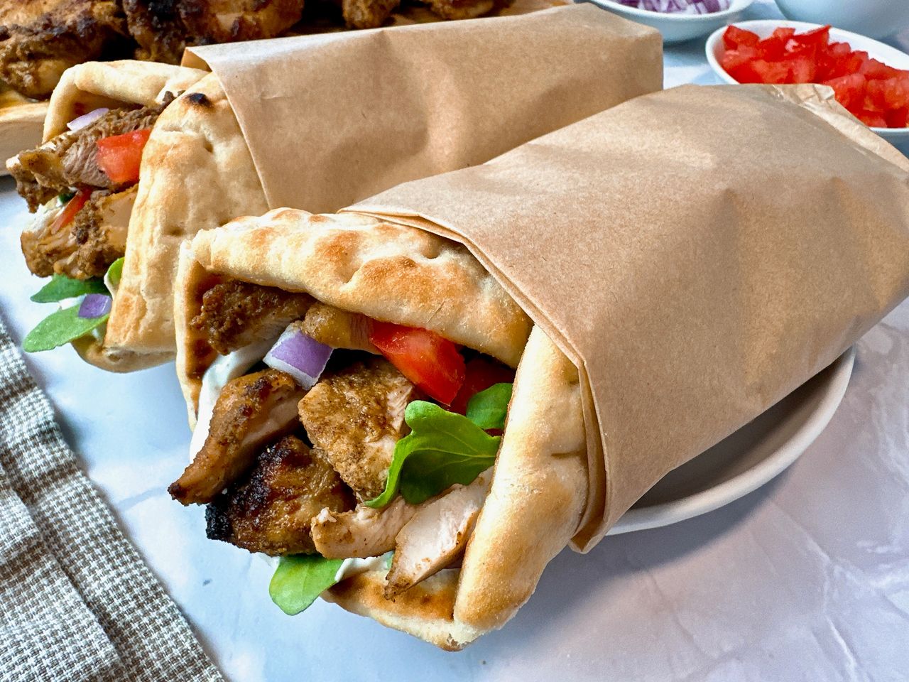 chicken shawarma wraps on a white plate