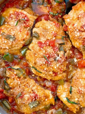 chicken thighs and vegetables in a skillet