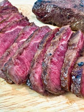 sliced steak on a cutting board