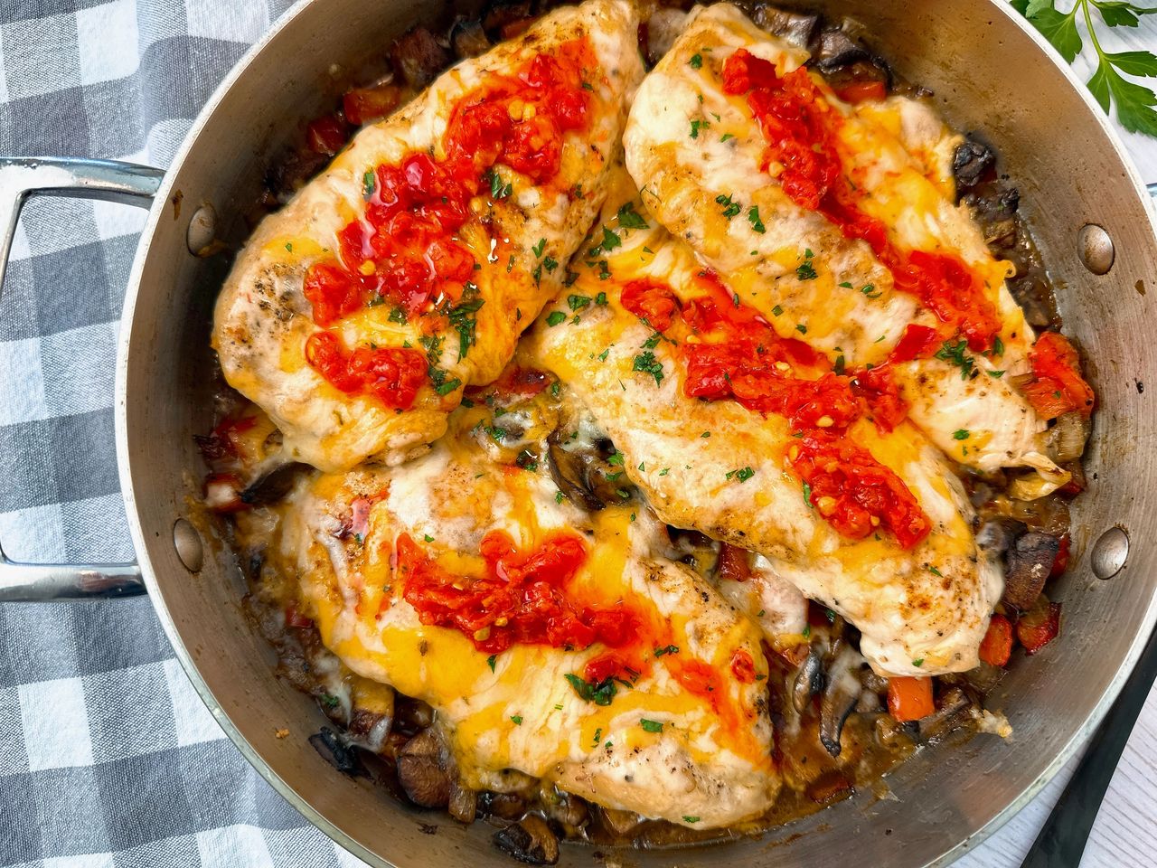chicken breasts and Italian peppers in a pan