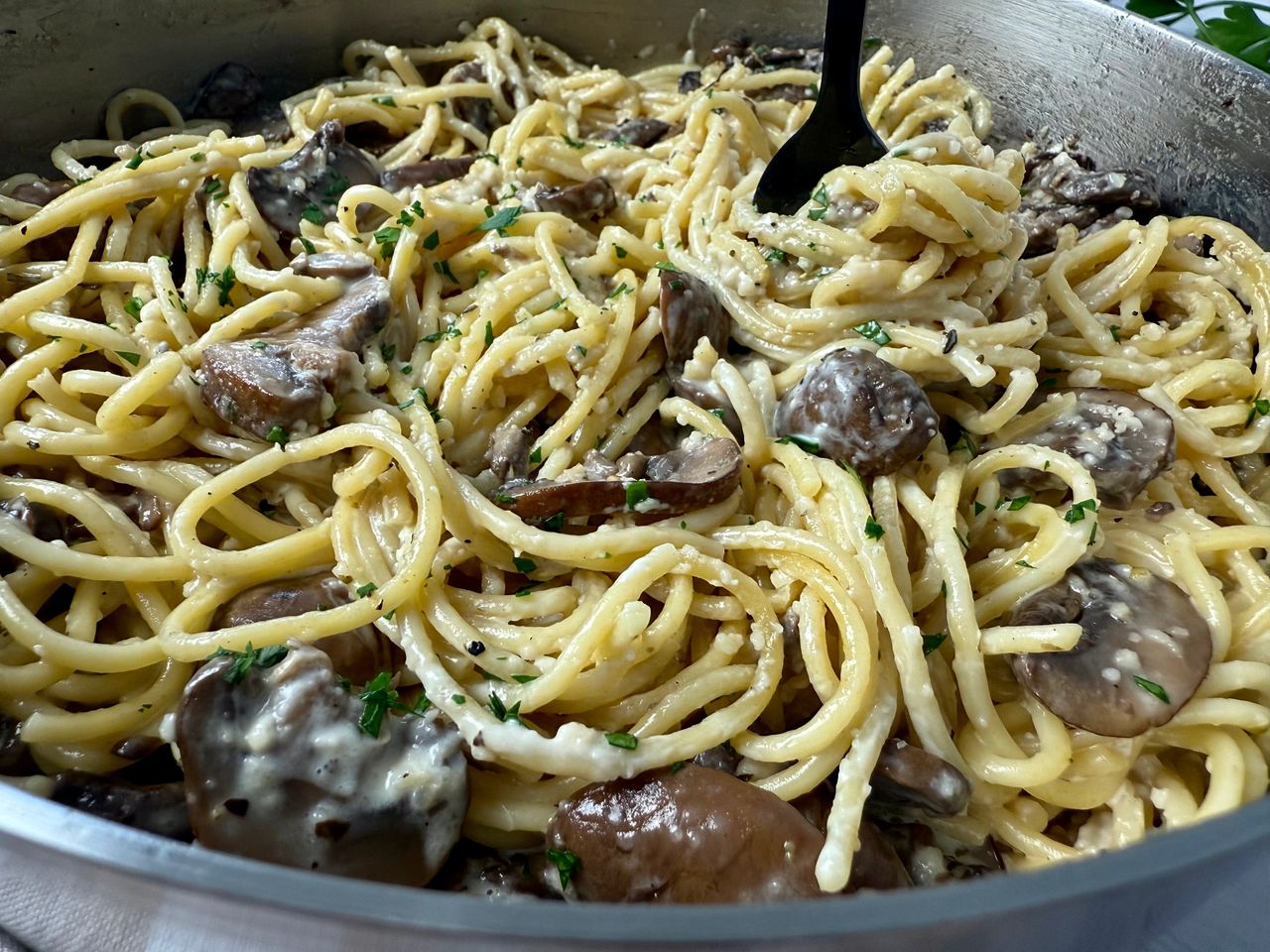 Pasta with Mushrooms in a skillet with a black fork