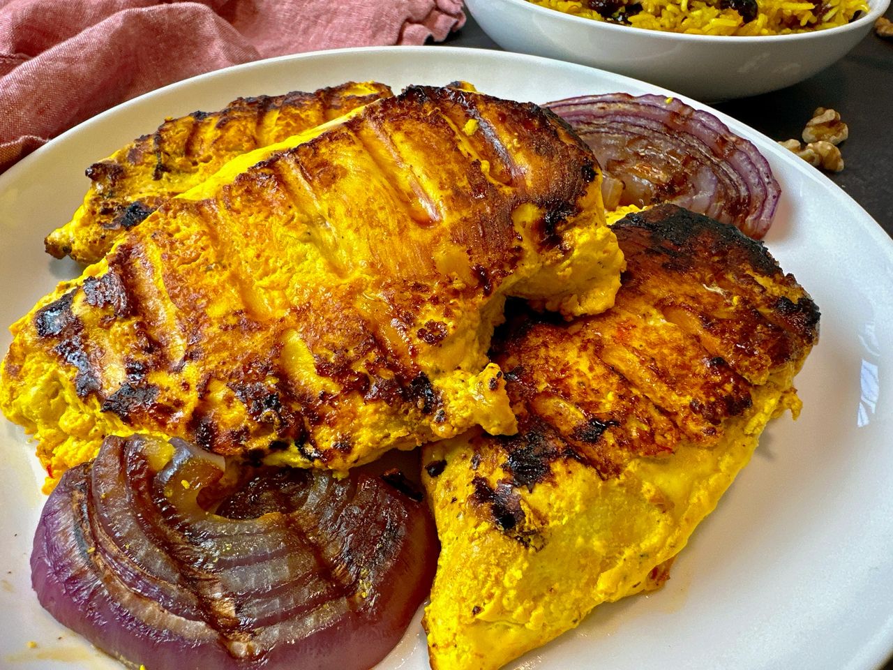 Saffron Chicken saffron chicken and red onion on a white plate