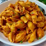 beef and pasta in a white bowl