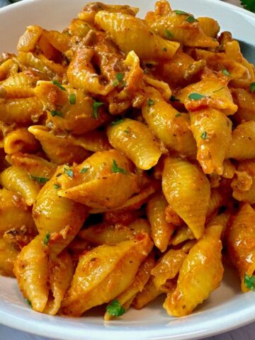 beef and pasta in a white bowl