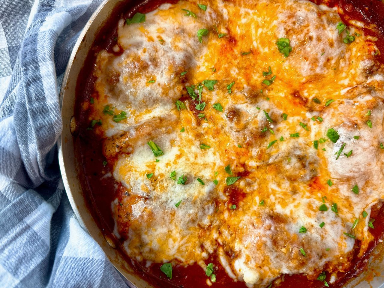 Chicken Thighs Marinara chicken thighs and marinara sauce with cheese in a pan