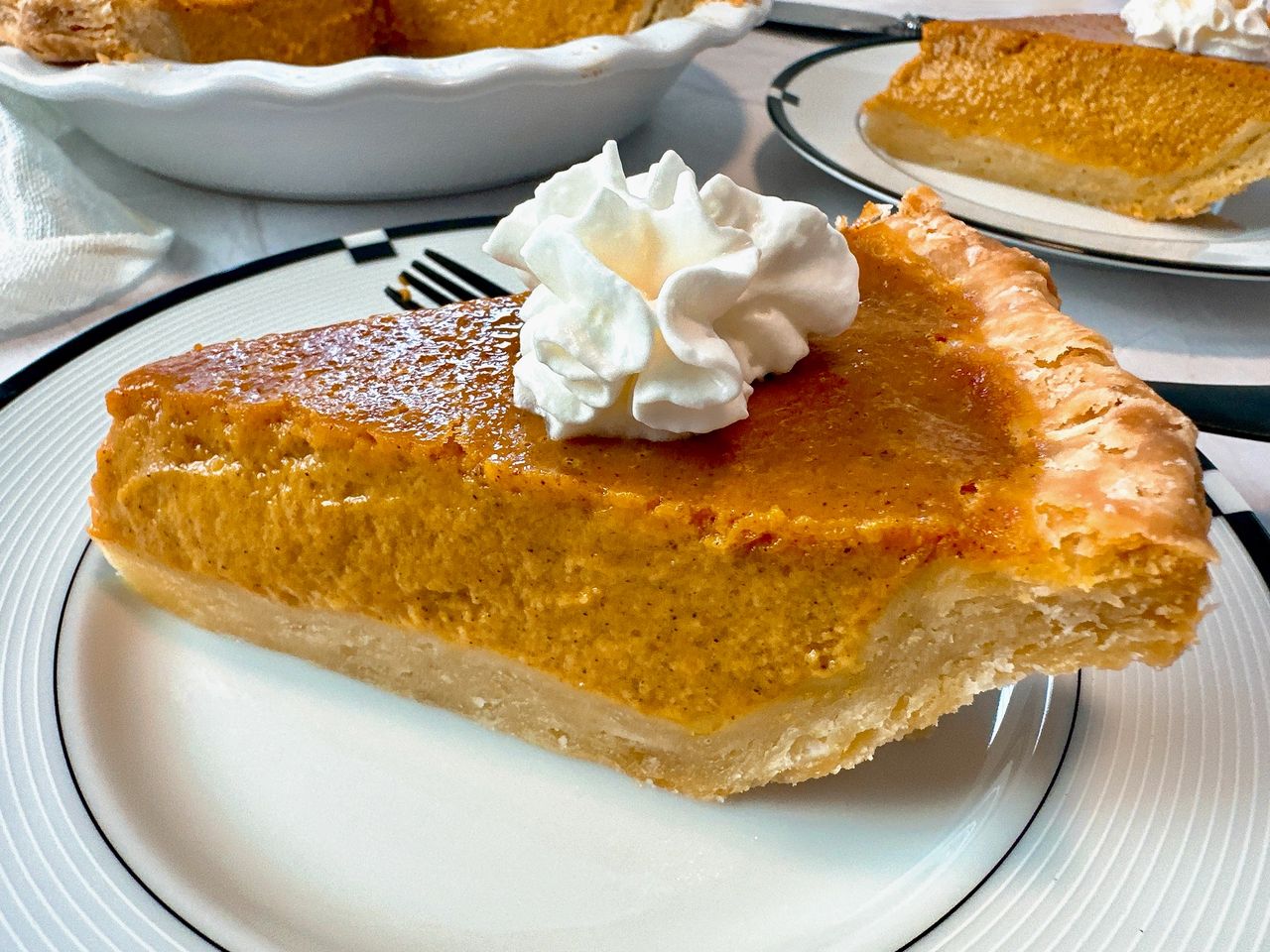 Ultimate Pumpkin Pie slice of pumpkin pie on a plate