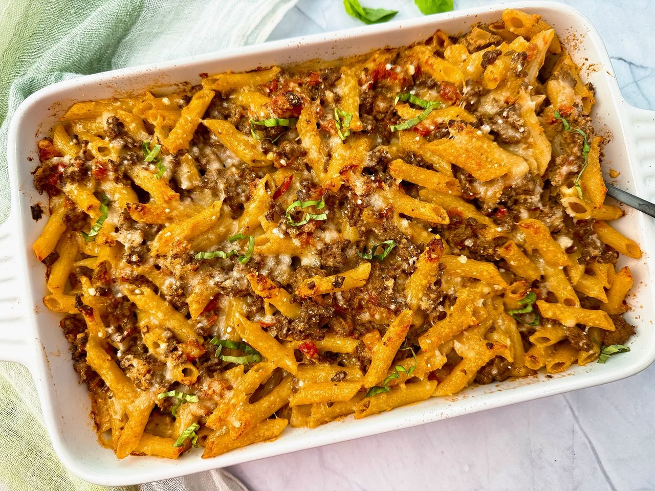 Maltese Baked Pasta with pasta and beef in a white baking dish
