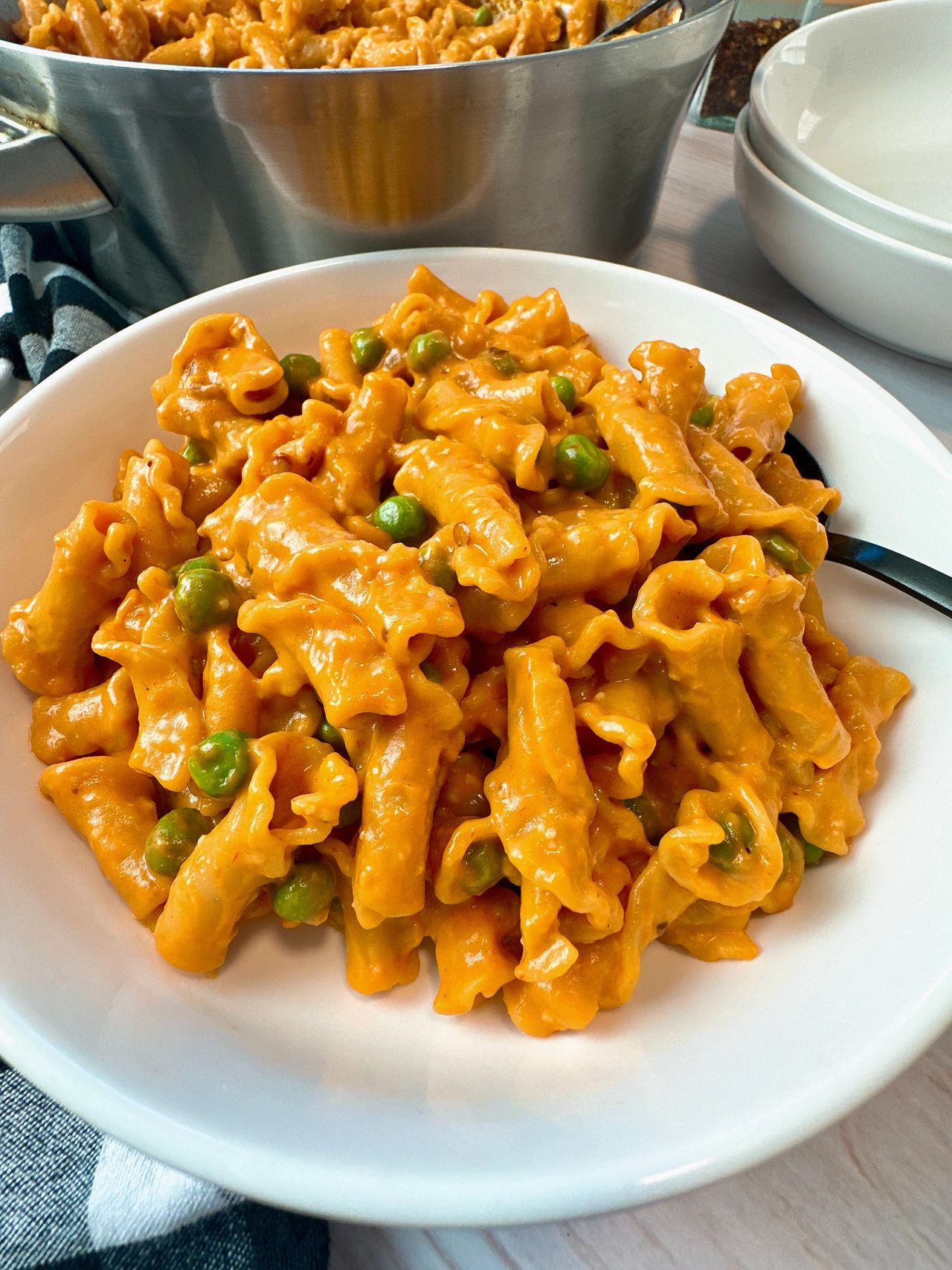 pasta and peas in a white bowl