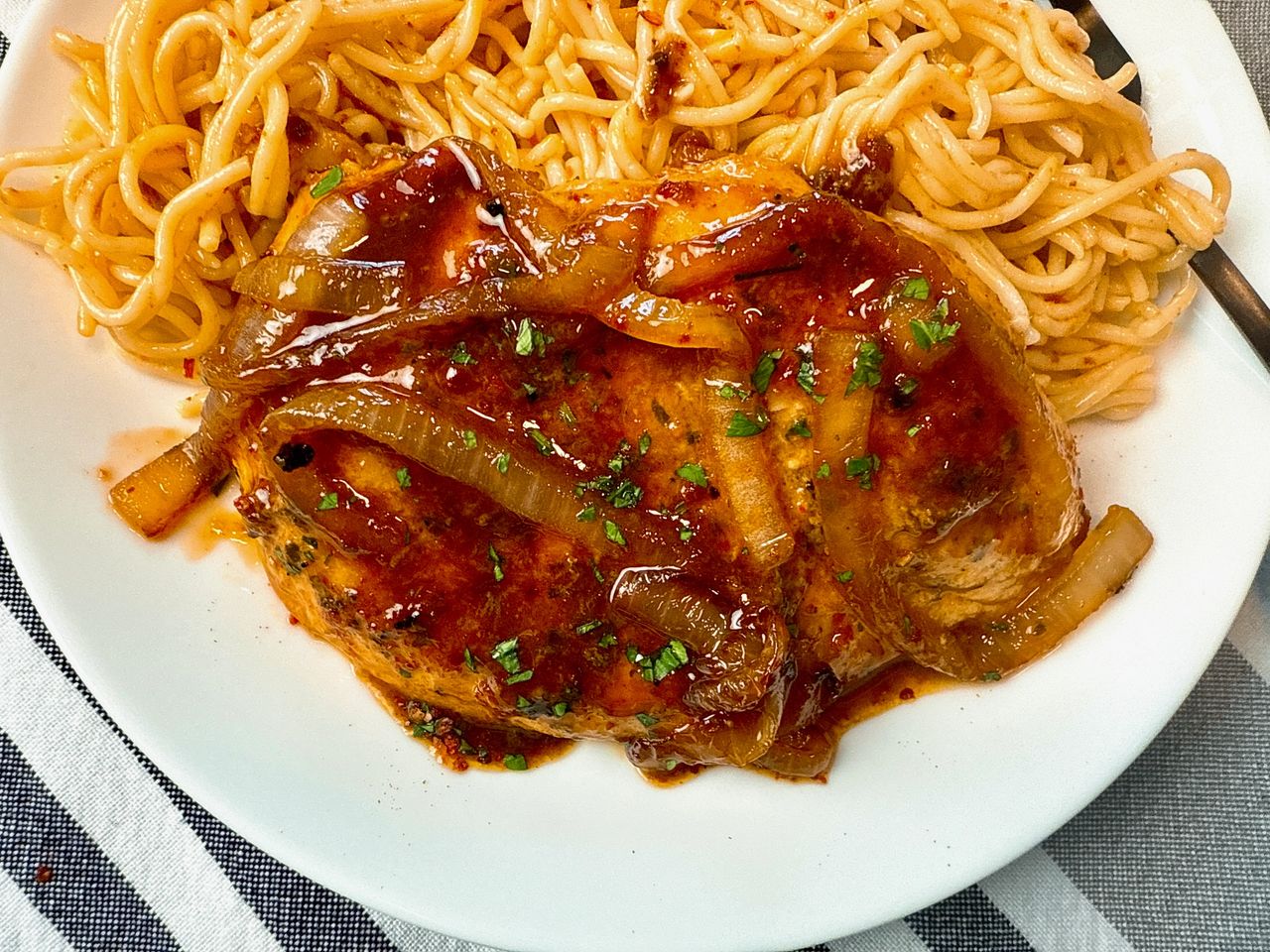 spicy hoisin chicken and noodles on a white plate