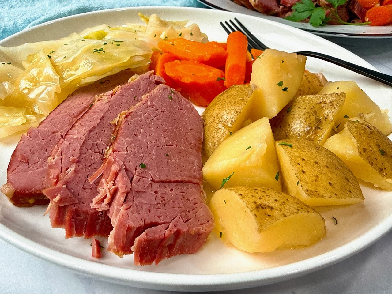 Corned Beef and Cabbage on a white serving plate